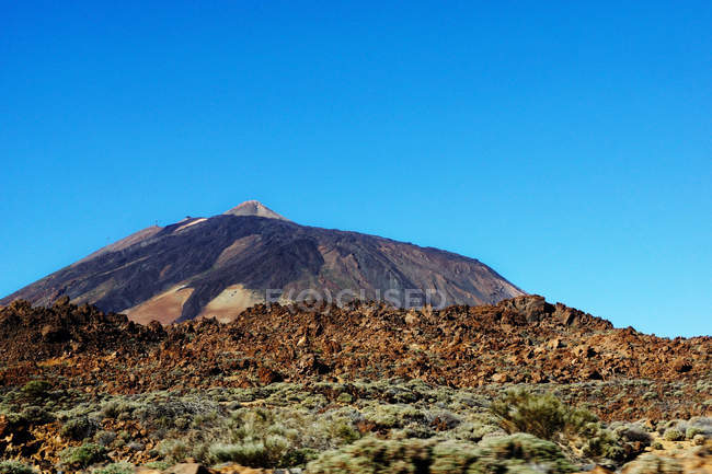 Volcano of Teide and burnt wild area of Tenerife, Spain on background of clear blue sky — Stock Photo