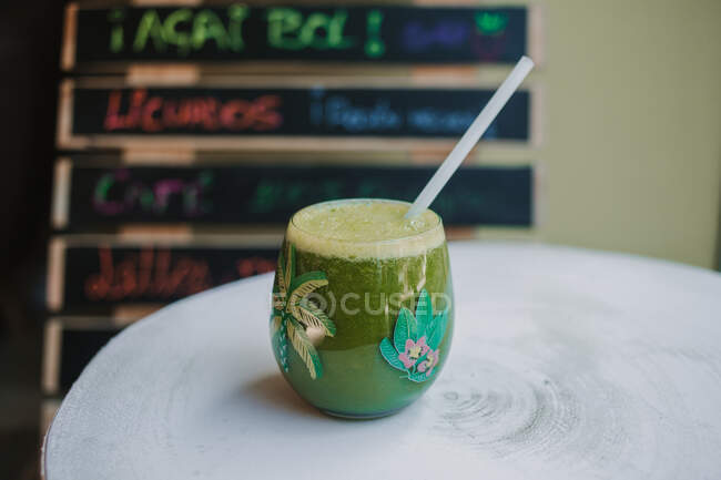 Bolla schiumosa gustoso frullato verde profumato in vetro su tavolo di legno — Foto stock