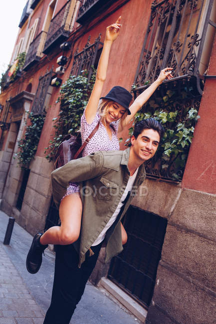 Young cheerful couple in casual clothes having fun during dating outdoors — Stock Photo
