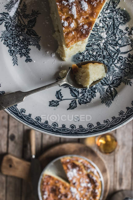 From above cottage cheese baked pudding served on plate over served wooden table — Stock Photo