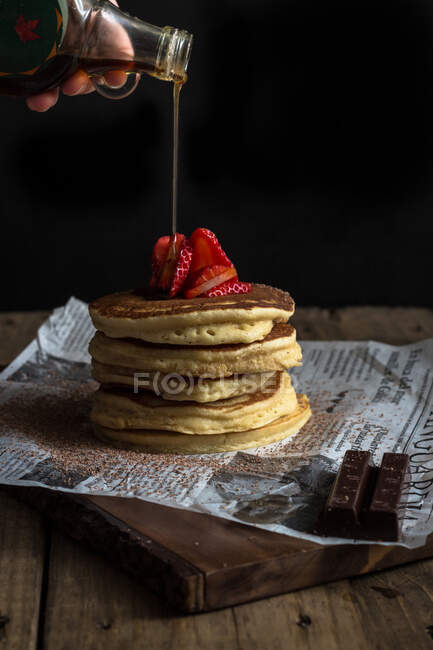Pancake with strawberries and chocolate covered in syrup — Stock Photo