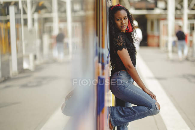 Young cheerful beautiful hispanic woman standing on train cabin in Berlin looking at camera — Stock Photo