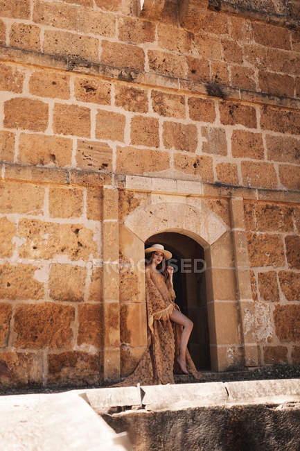 Elegant woman in ancient fortress — Stock Photo