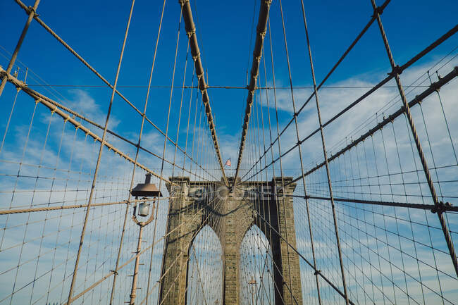 Brooklyn bridge view from below with a blue sky background in New York — Stock Photo