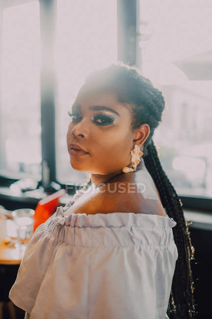 Side view portrait of beautiful curvy black young woman with bright make-up in off-shoulder dress — Stock Photo