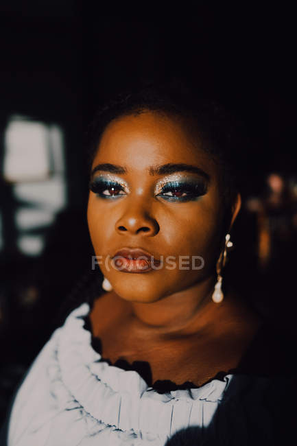 Portrait of beautiful curvy black young woman with bright make-up in off-shoulder dress looking at camera — Stock Photo
