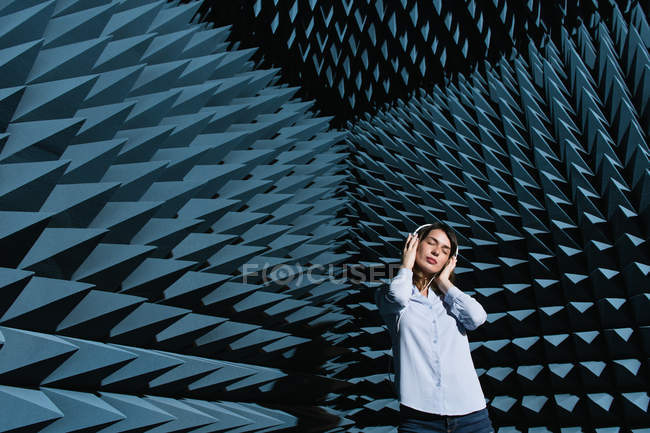 Woman in sound room listening to music — Stock Photo