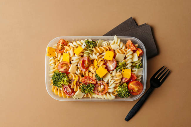 Lunchbox with pasta and plastic fork — Stock Photo