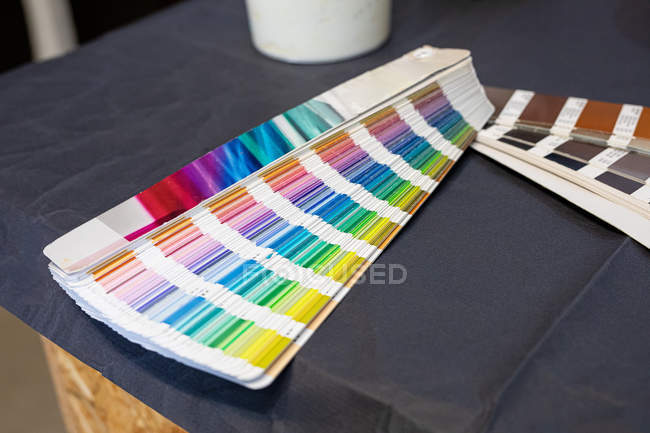 Colorful papers with different sets of color spectrum on table in workshop — Stock Photo
