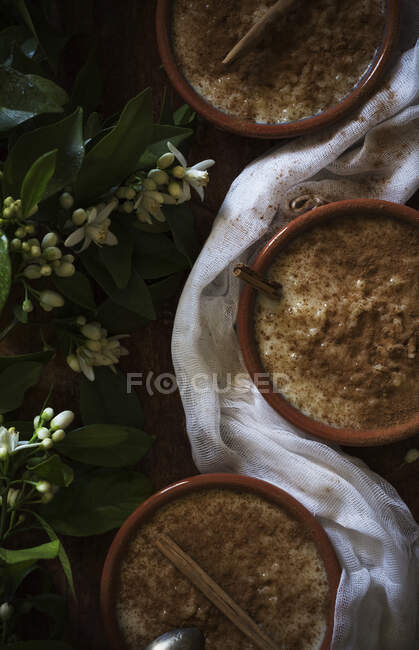 Flowers near tasty porridge — Stock Photo