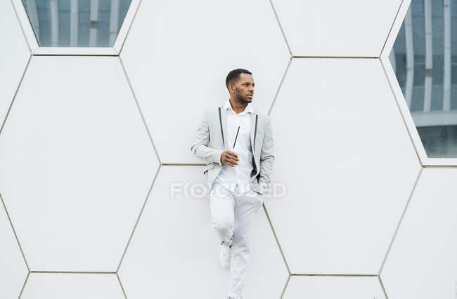 Black man with coffee standing in downtown — Stock Photo