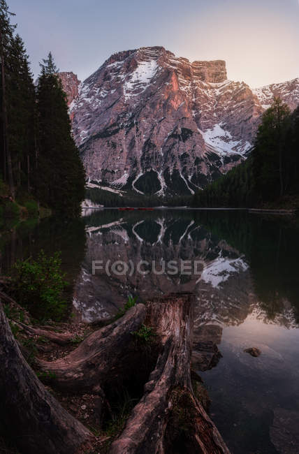 Landscape of  round pond on lush green lawn reflecting sky and mountains in Dolomites, Itlay — Stock Photo