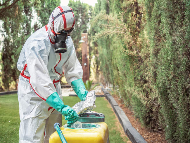 Fumigation specialist putting package into yellow device — Stock Photo