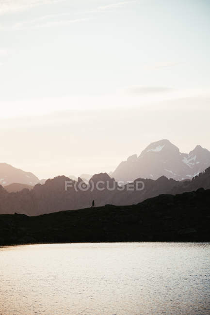 Majestic mountain landscape with human silhouette — Stock Photo