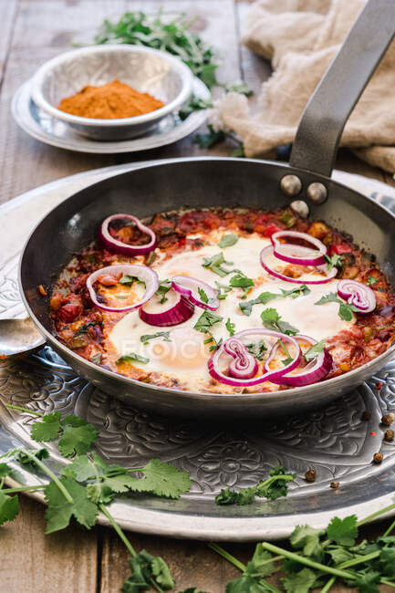 Fragrant shakshuka with onion rings in pan — Stock Photo