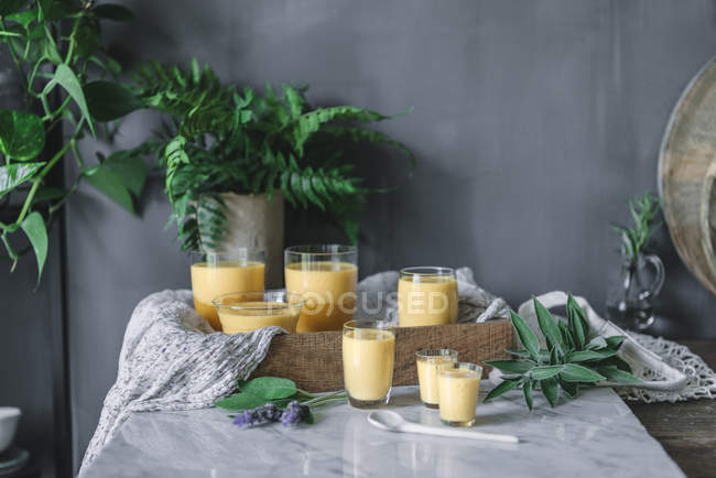 Mousse de manga aromática saborosa em óculos em mesa de mármore branco — Fotografia de Stock