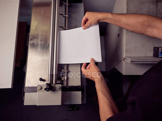 Unrecognizable employee using professional tools for book making — Stock Photo