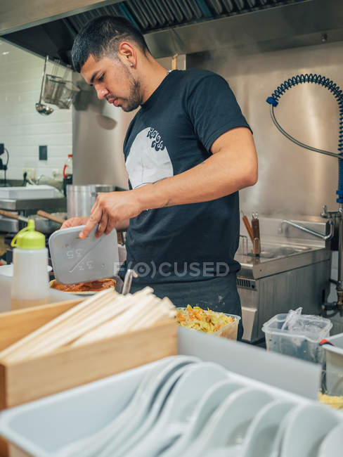 Multiracial man cooking Japanese dish in Asian restaurant indoors — Stock Photo