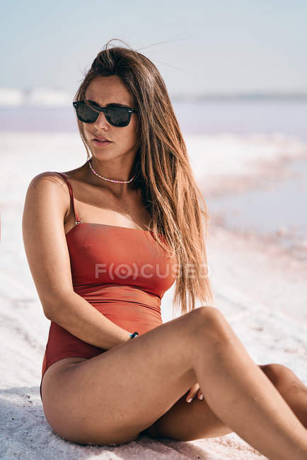 Tanned female in swimwear relaxing on salty lake shore — Stock Photo