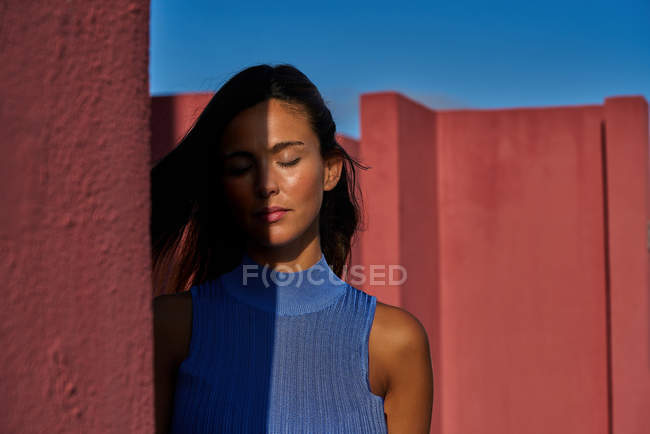 Close-up of beautiful woman in blue dress with closed eyes — Stock Photo