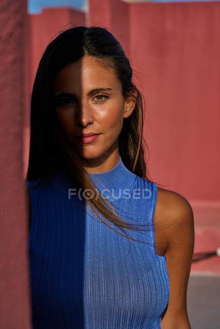 Nahaufnahme einer schönen Frau im blauen Kleid, die in die Kamera blickt — Stockfoto