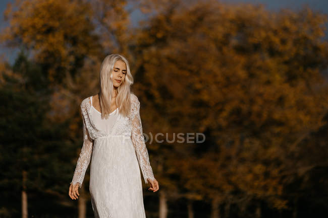 Beautiful blonde woman gazing at autumn countryside — Stock Photo