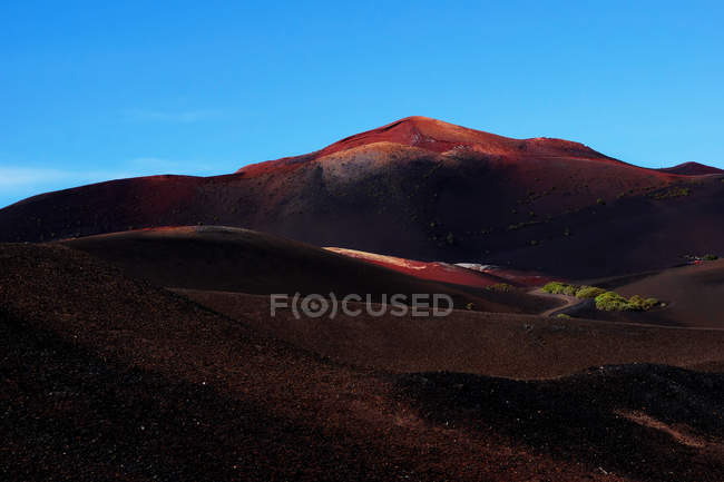 Picturesque view of volcanic terrain with solidified lava in wild area on island of Lanzarote Spain — Stock Photo