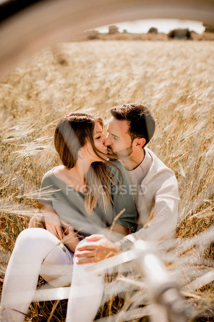 Loving couple resting on rye field — Stock Photo