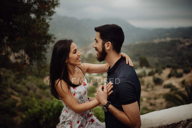 Couple aimant embrasser tout en se tenant contre la vallée rurale — Photo de stock