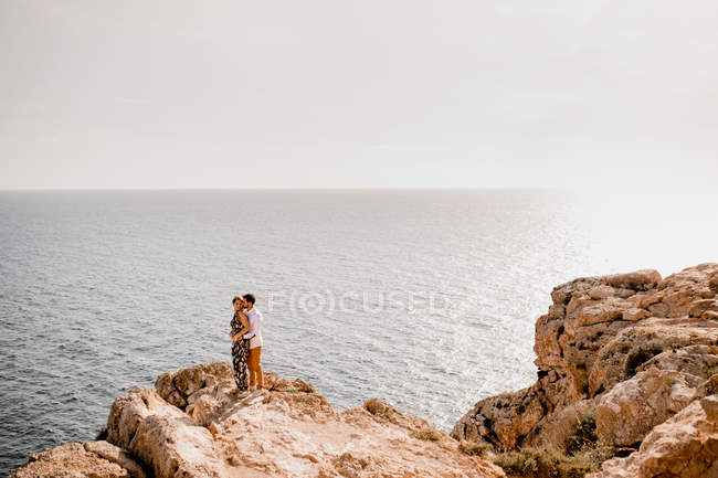 Paar umarmt sich auf Felsen — Stockfoto