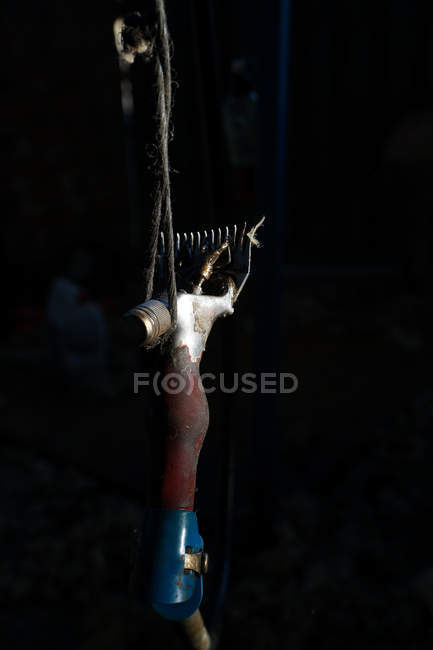 Professional sheep shearing razor hanging on rope in dark barn on farm — Stock Photo