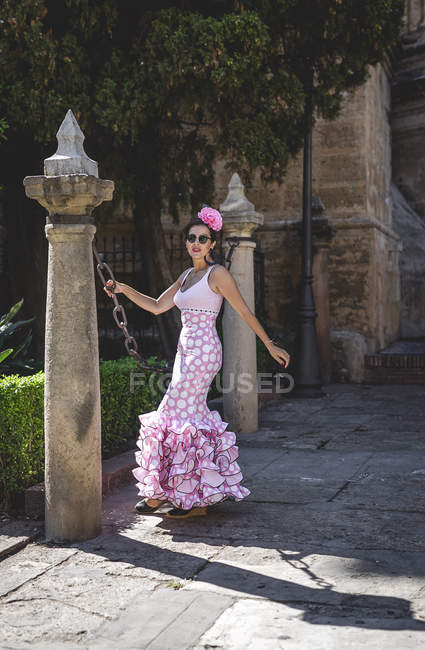 Eccentric woman in colorful pink costume on summer street — Stock Photo