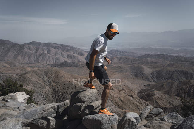 Olhar turístico enquanto está na borda do cânion pitoresco — Fotografia de Stock