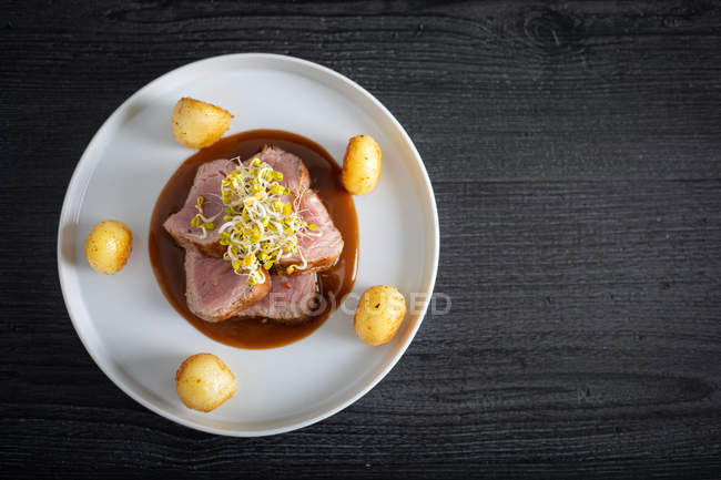Duroc sirloin with orange ginger soy and potatoes on plate — Stock Photo