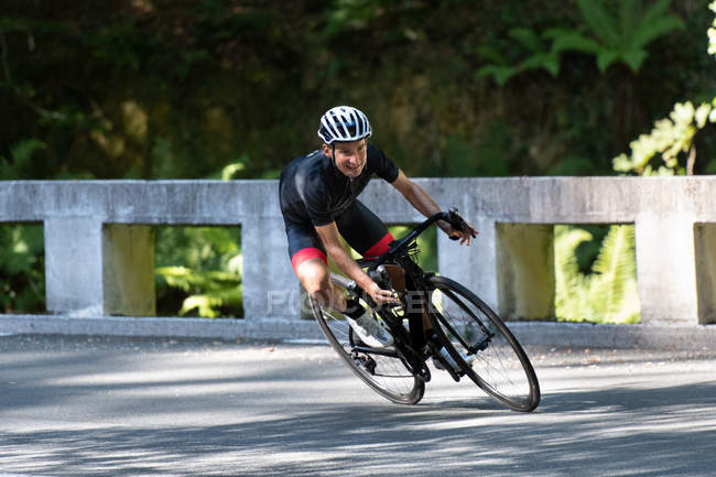 Professional cyclist riding bike in park — Stock Photo