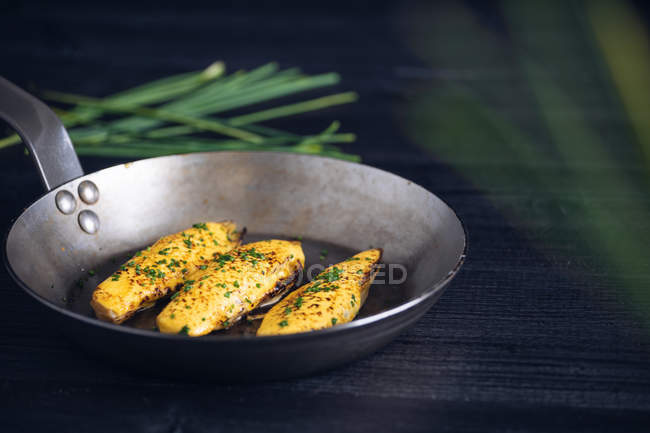 From above Endives with hollandaise sauce au gratin in pan decorated with green — Stock Photo