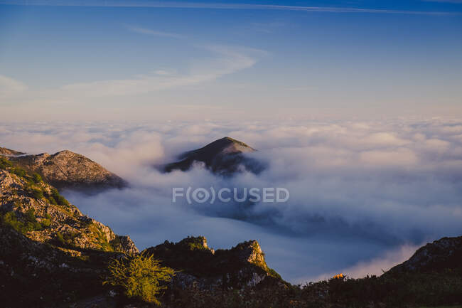 З гори видніється чудовий краєвид з блакитним небом і горами серед густих буйних хмар Іспанії в сонячну погоду. — стокове фото