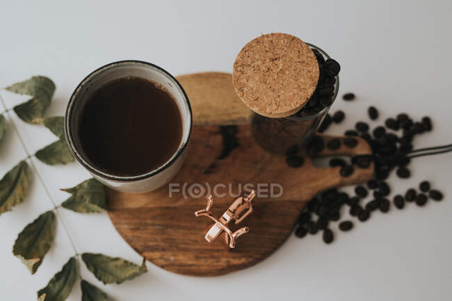 Mug and decorative elements on wooden stand on table — Stock Photo