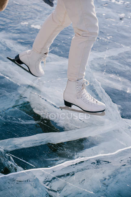 Cropped image of Woman skating on frozen river — Stock Photo
