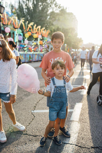 Fröhliche Kinder genießen süße Zuckerwatte auf der Straße — Stockfoto