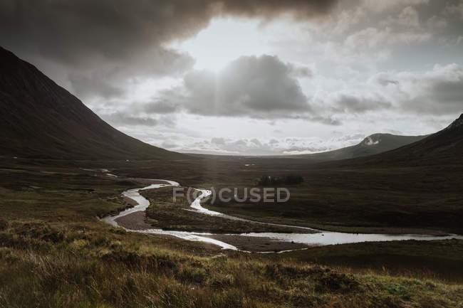 Autumn valley covered with water patches after rain surrounded by foggy hills in Scotland — Stock Photo