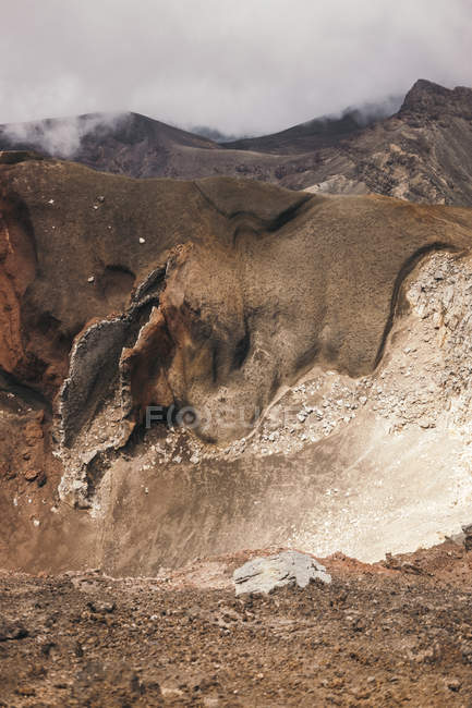 Rocky terrain with sky in clouds over cliffs in Tongariro in New Zealand — Stock Photo