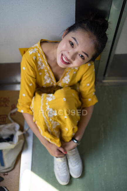 Cheerful female traveler in stylish dress at train — Stock Photo