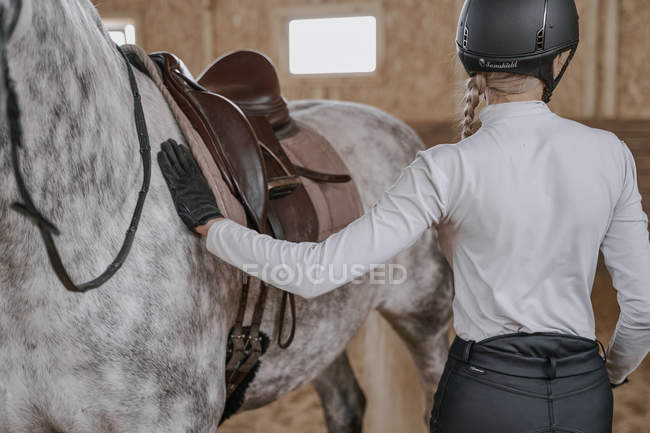 Кіннота, що стоїть з сірим конем на круглому майданчику — стокове фото