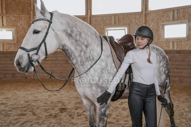 Rider with dapple gray horse in round arena — Stock Photo