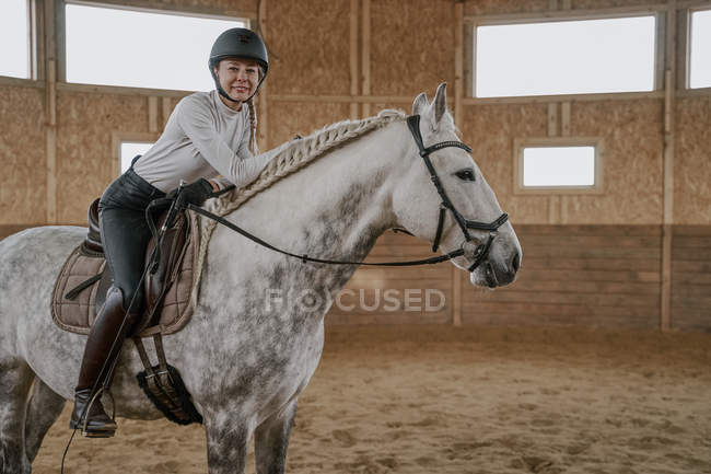 Jinete a caballo gris manzana en arena redonda - foto de stock