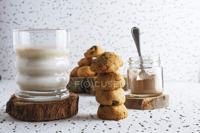 Composition of organic homemade cookies with jar of cacao powder and glass of tasty milk — Stock Photo