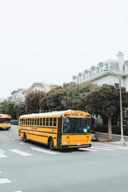 Big yellow bus driving on road in city — Stock Photo
