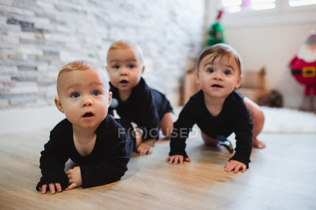 Happy babies sitting on floor — Stock Photo