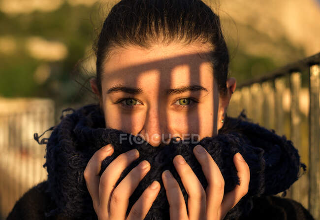 Pleased young lady with scarf on sunny day — Stock Photo